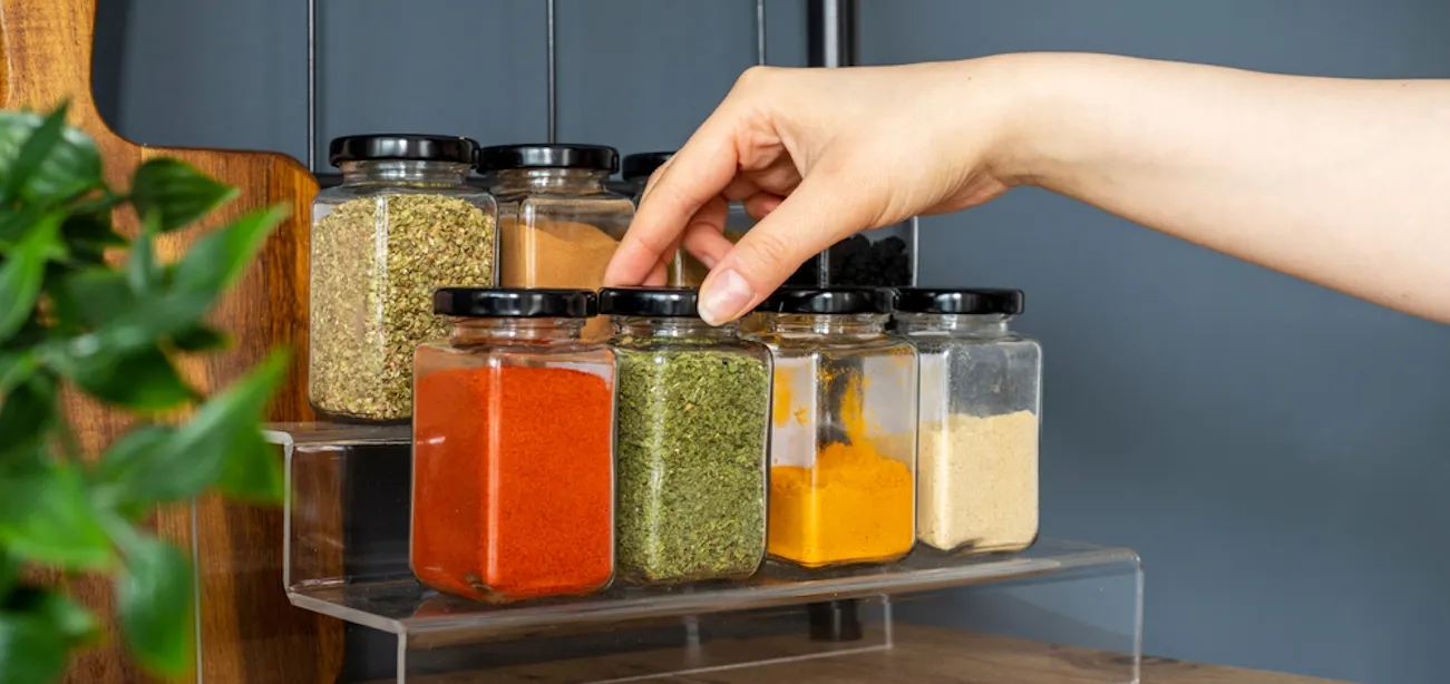 Person selecting different spices that replaces coriander in a meal