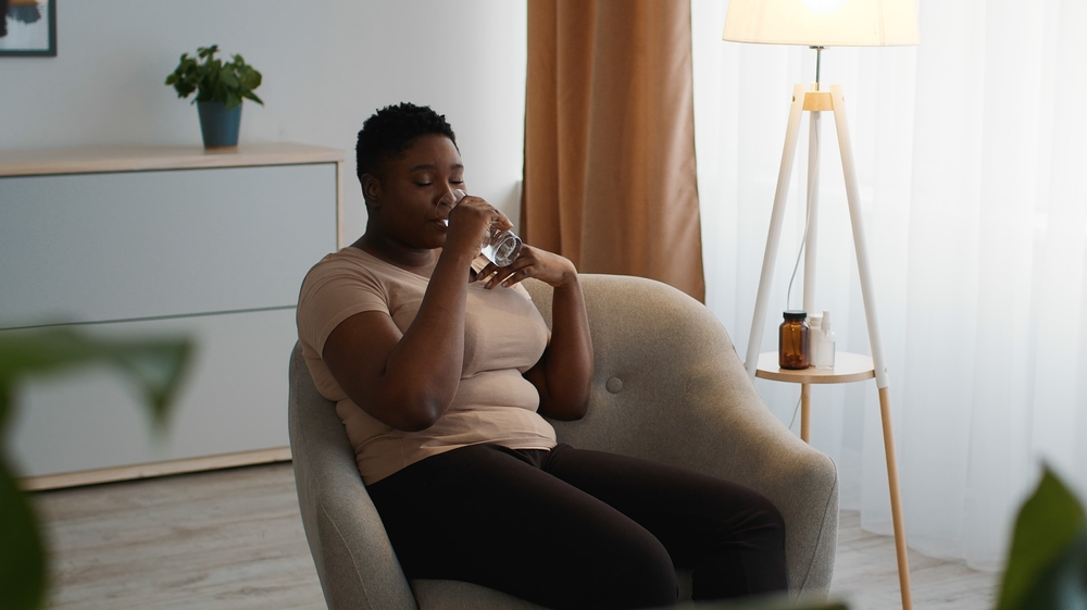 Lady taking natural PCOS supplements for hormonal balance and fertility support