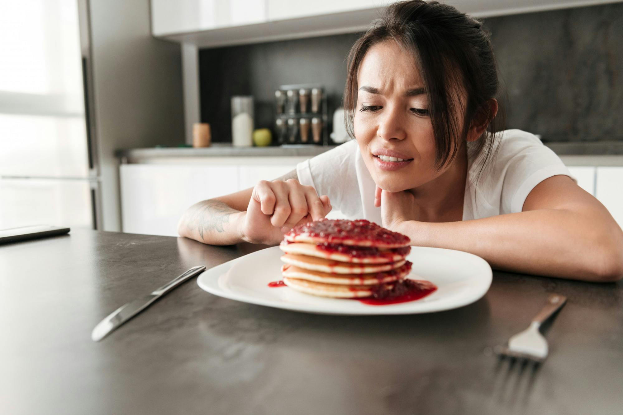 A lady looking at an unhealthy prediabetes meal