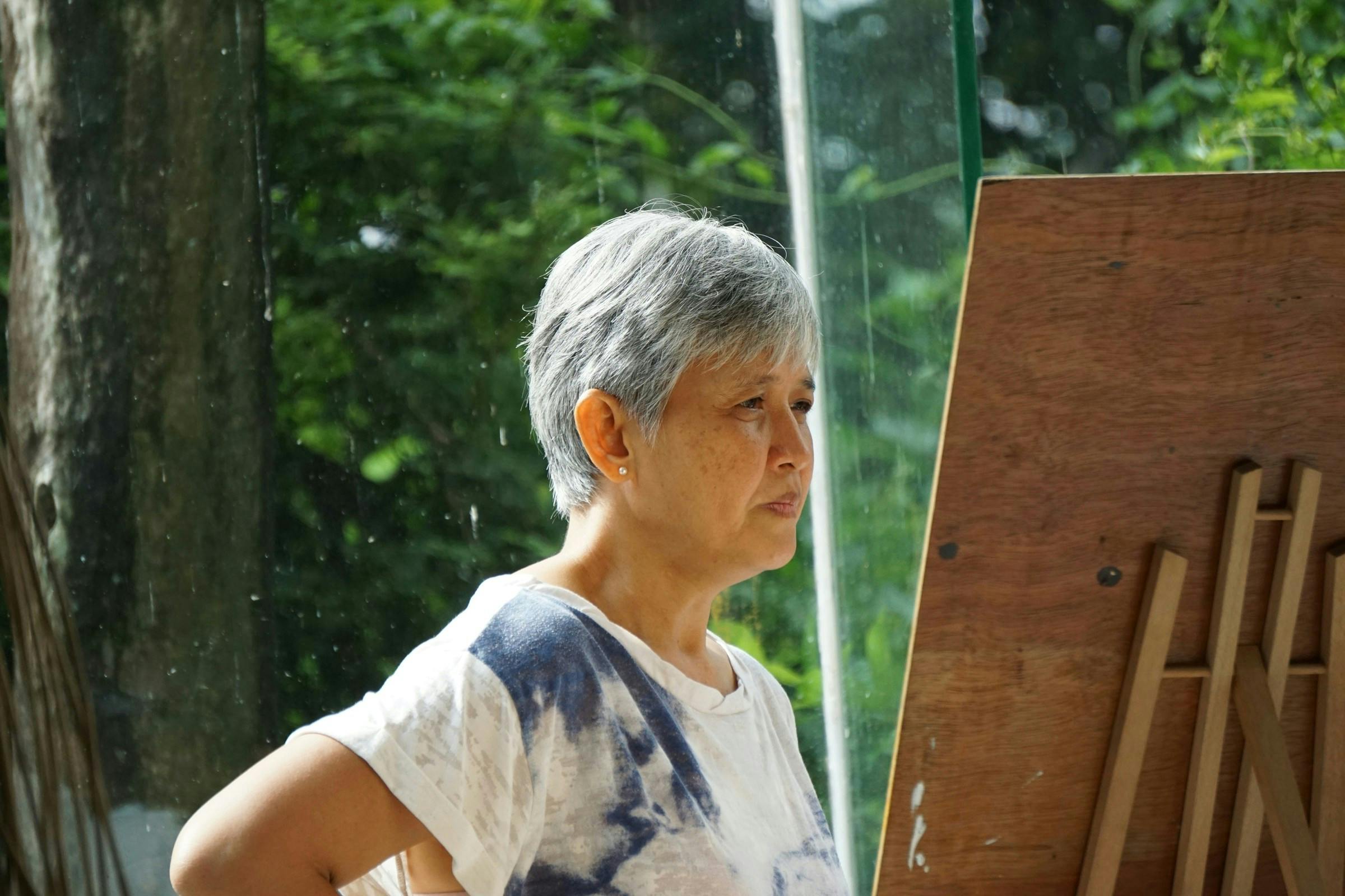 A woman engaging in painting to stay healthy
