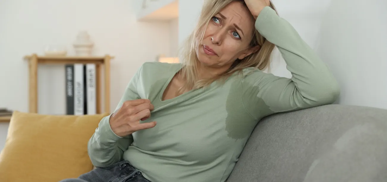 Woman managing hot flashes during surgical menopause