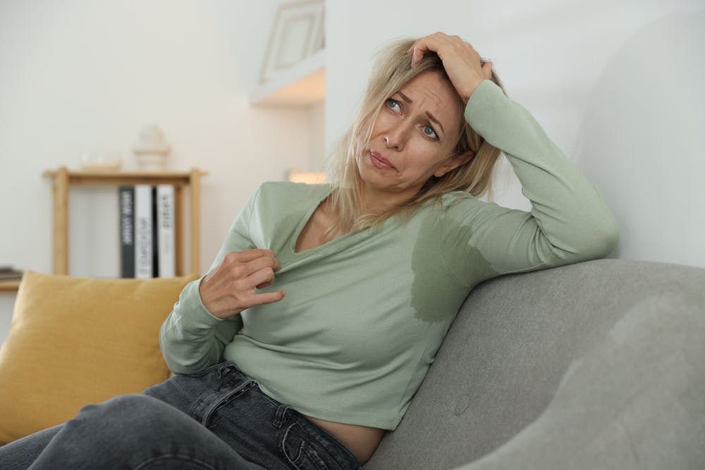 Woman managing hot flashes during surgical menopause