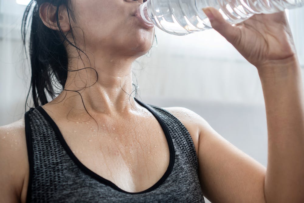 A person hydrating to maintain a healthy metabolism