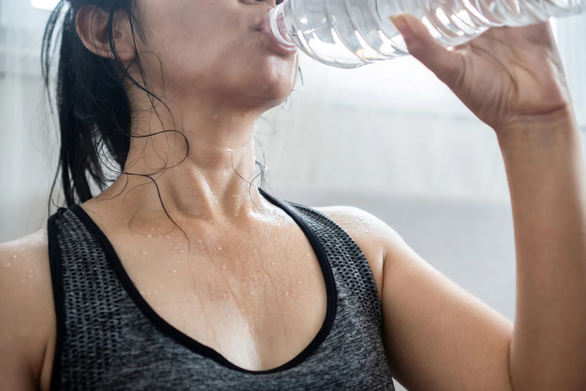 A person hydrating to maintain a healthy metabolism
