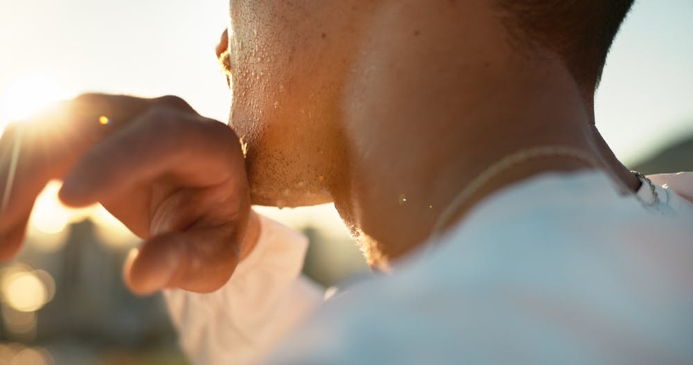 A person feeling very hot and sweating