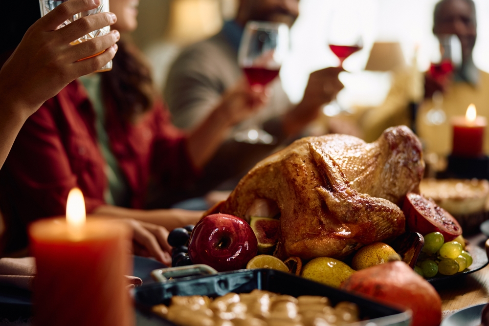 People having a heavy thanksgiving dinner with turkey
