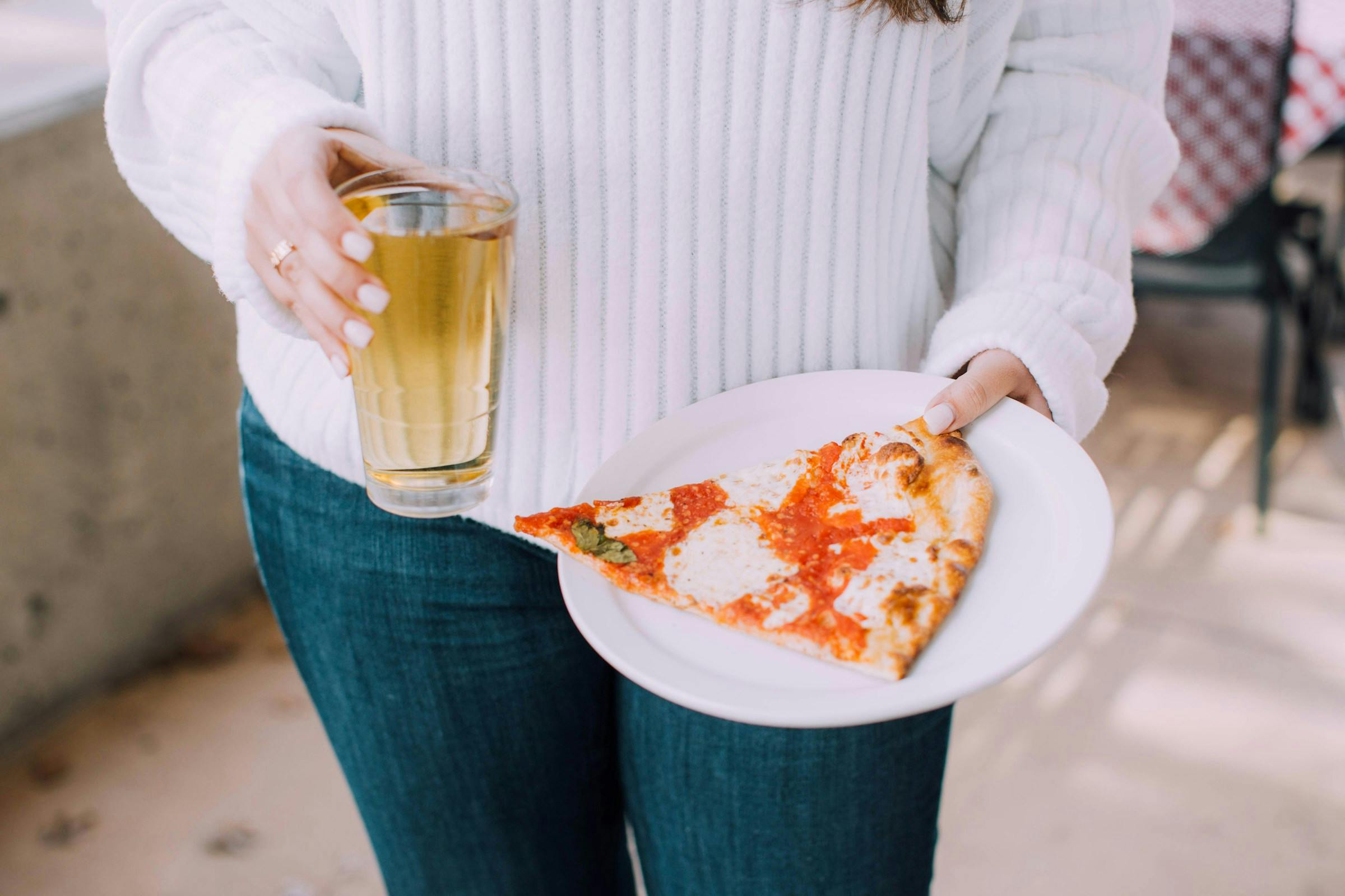 A lady with a slice of pizza on her plate