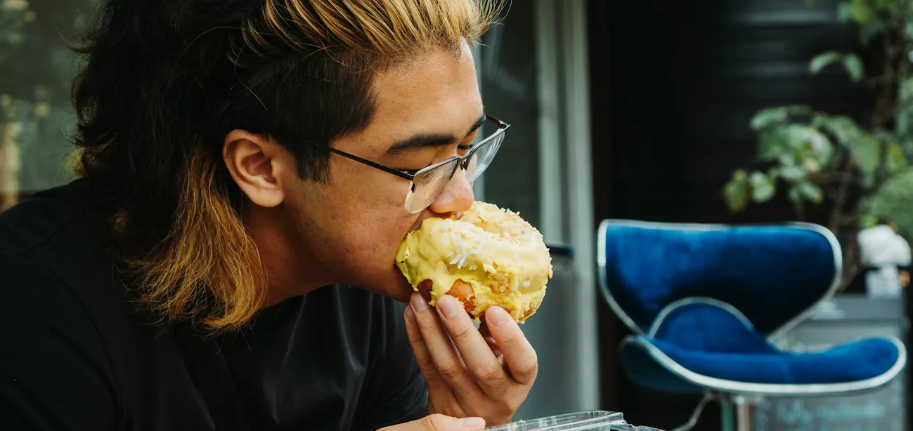 A man eating a high-carb high-sugar food