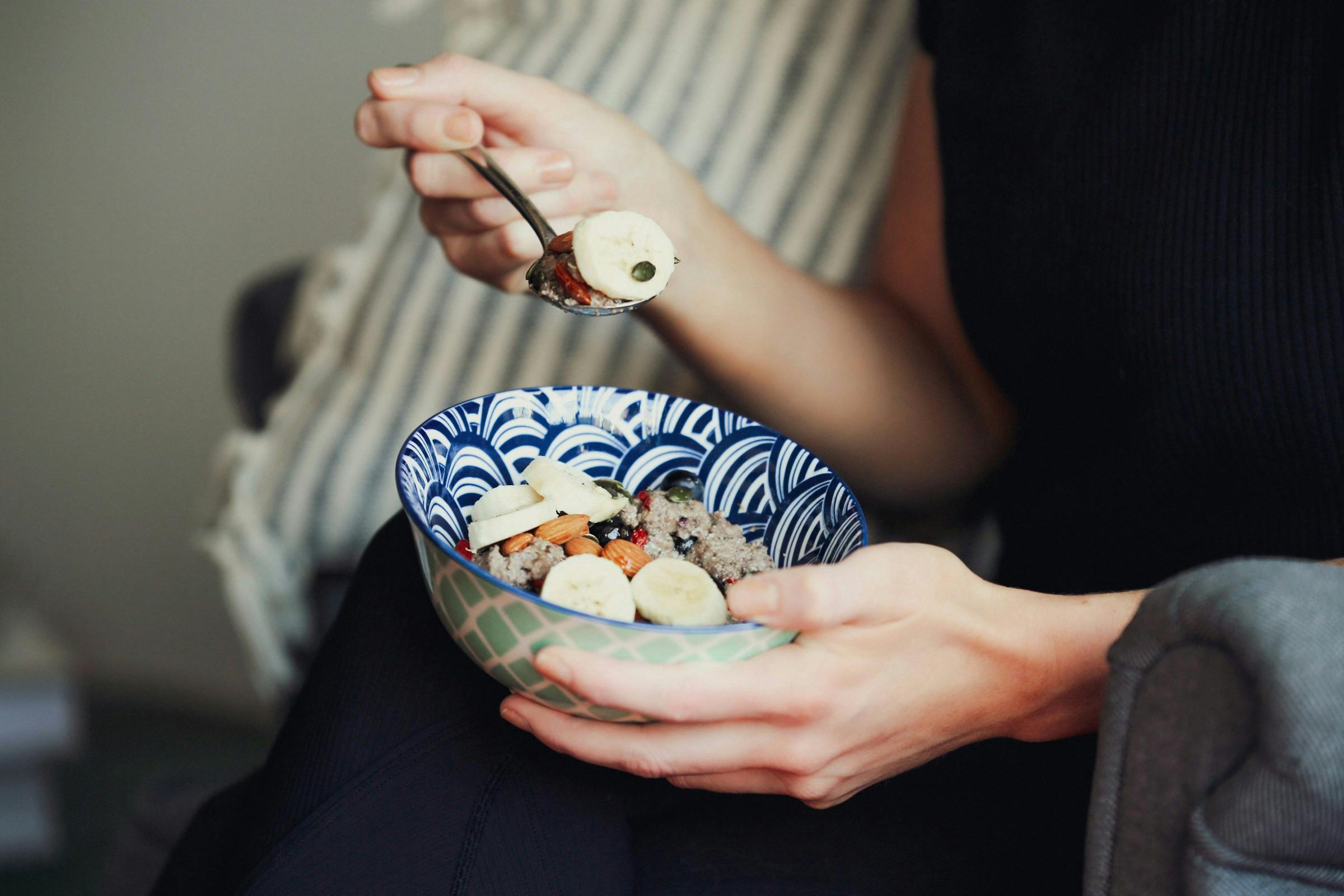 A person eating Healthy carbohydrate food examples like fruits and whole grains