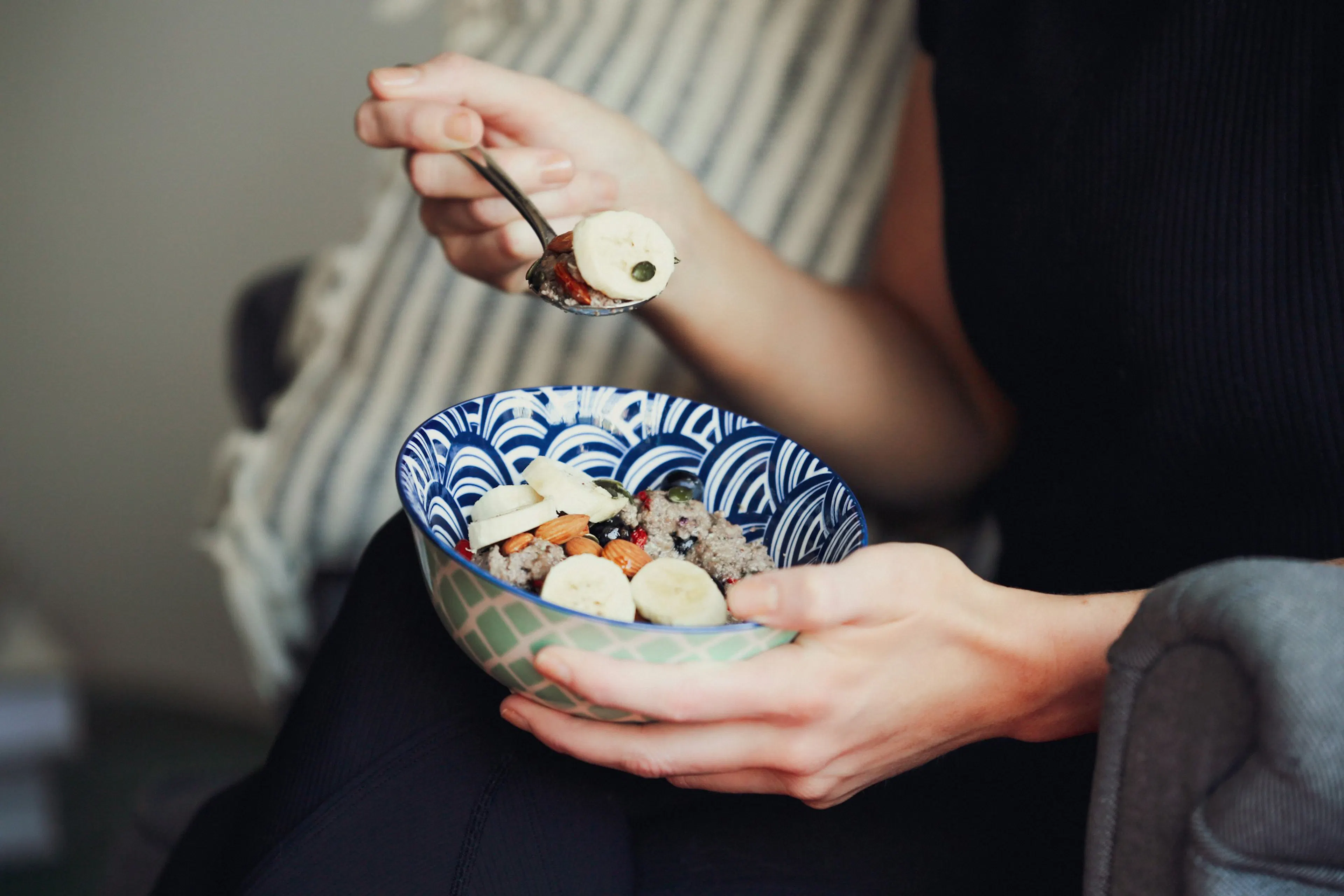 A person eating Healthy carbohydrate food examples like fruits and whole grains