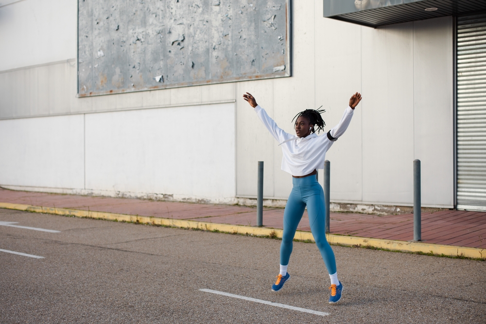 A lady doing jumping jacks