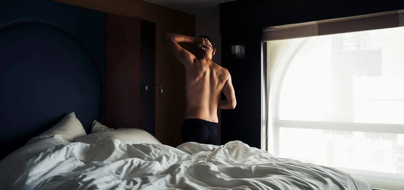 Person leaving bed deciding whether to go to the gym while feeling sick