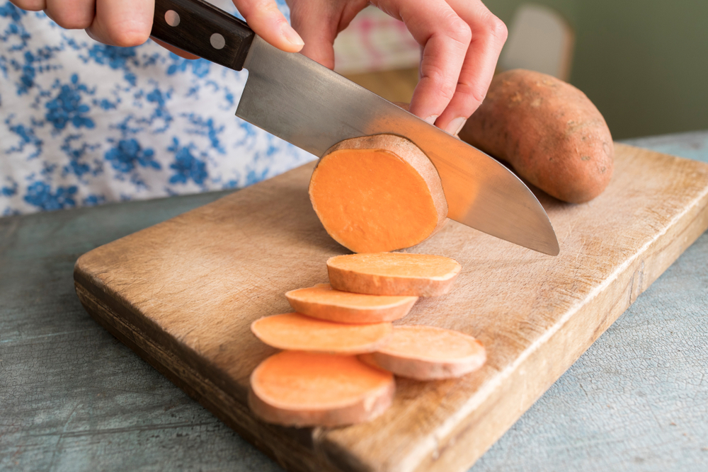 Sweet potato sliced to be roasted in oven – healthy carbs for energy