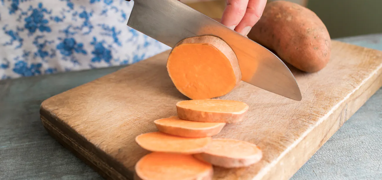 Sweet potato sliced to be roasted in oven – healthy carbs for energy