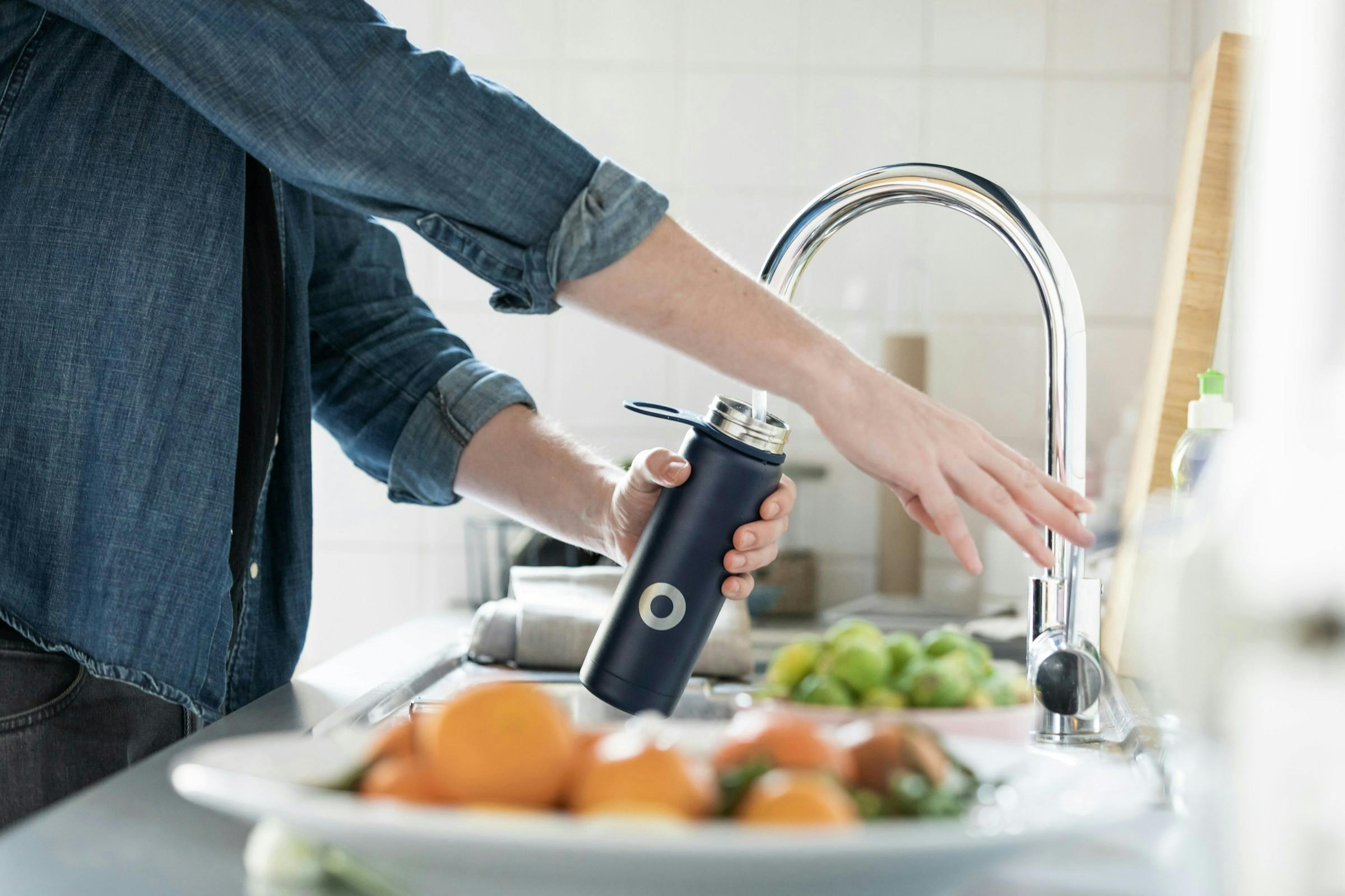 Person drinking water to hydrate