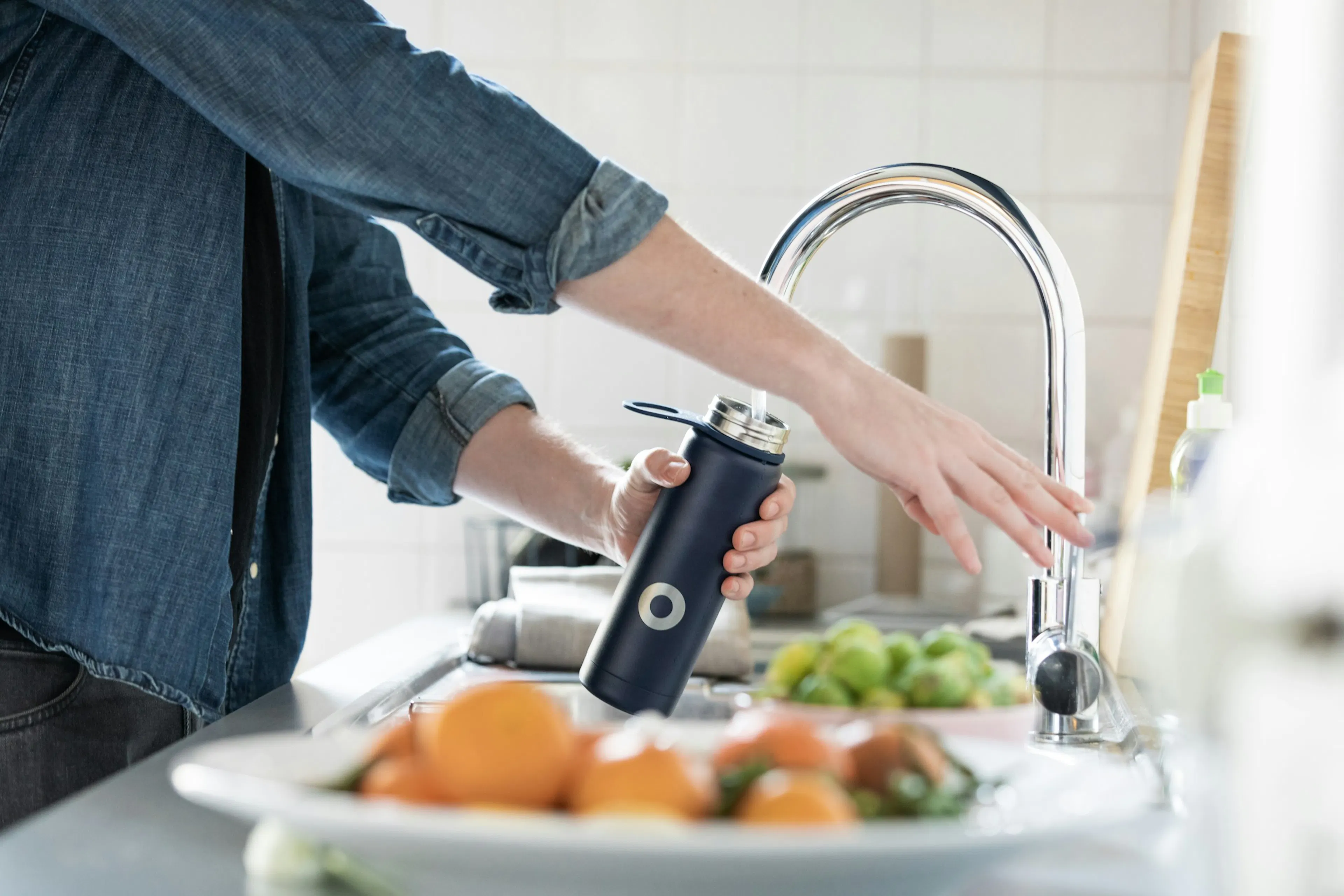 Person drinking water to hydrate