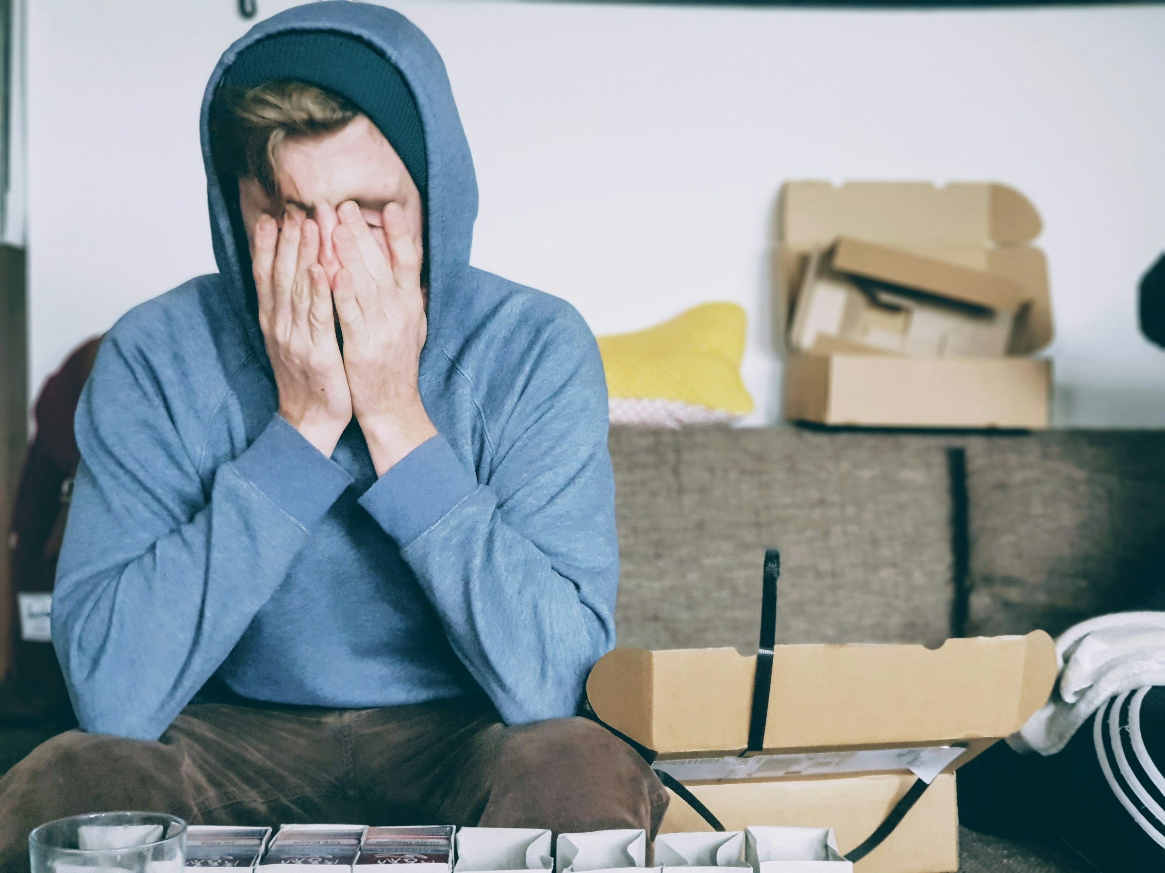 tired man holding his head in pain after waking up