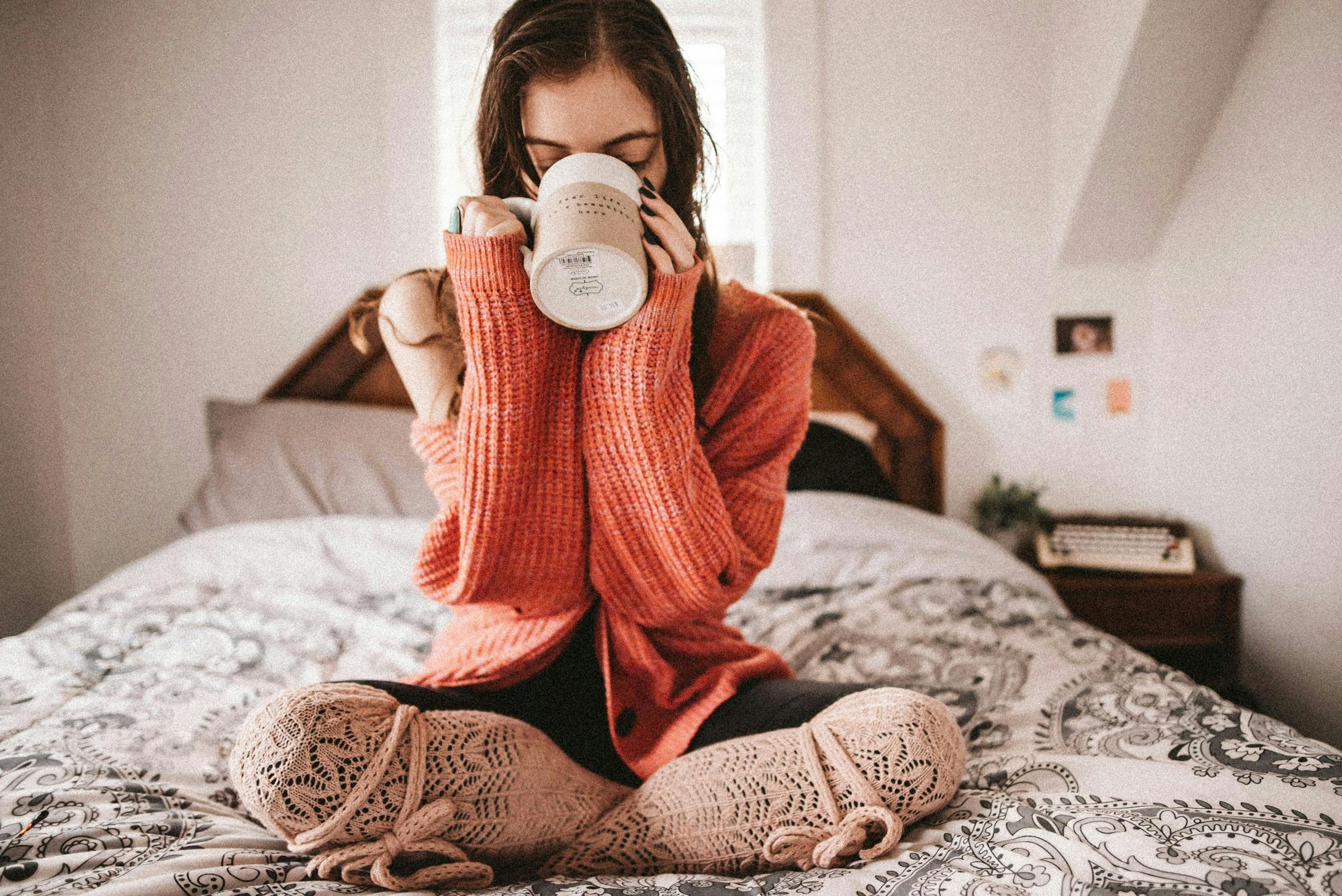A lady taking cinnamon tea in bed