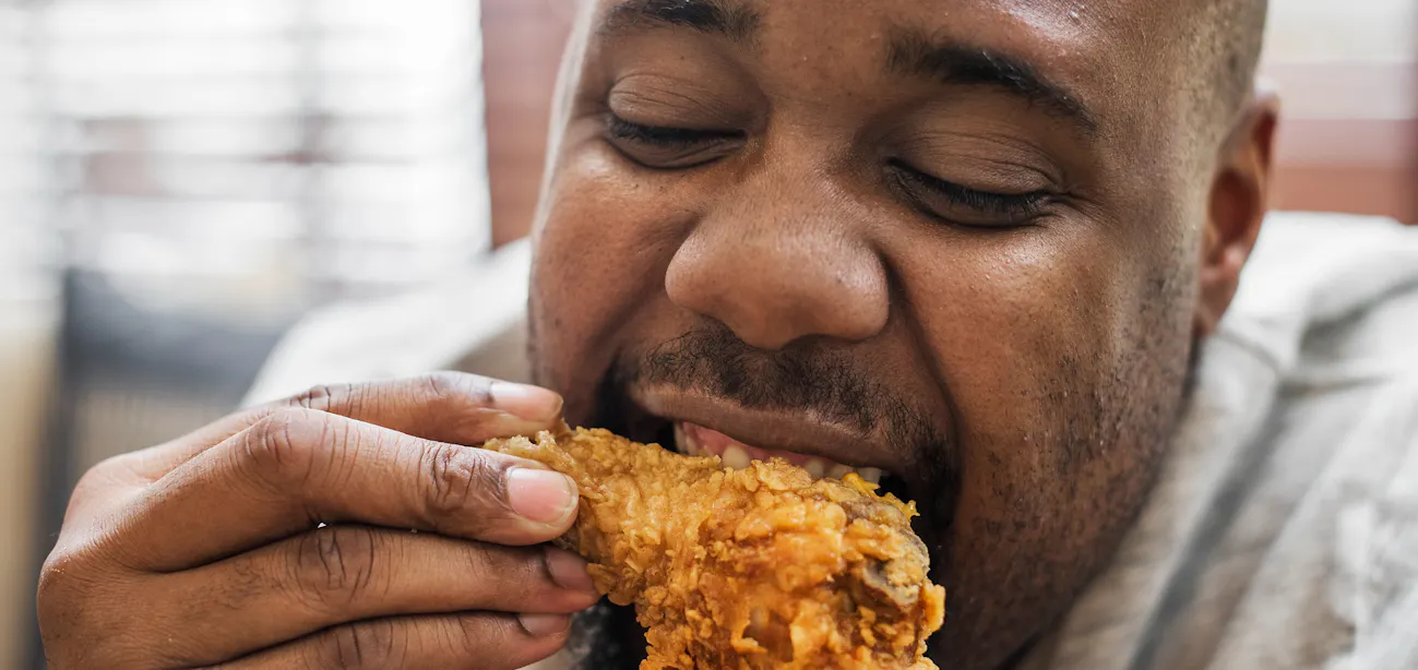 A man eating chicken