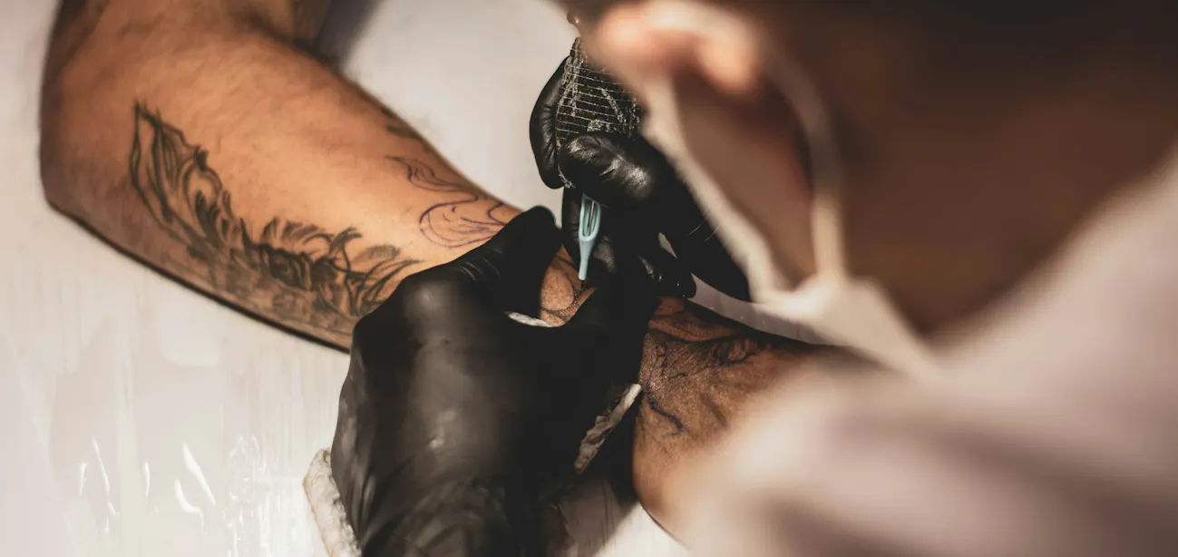 Tattoo artist preparing ink for diabetic client