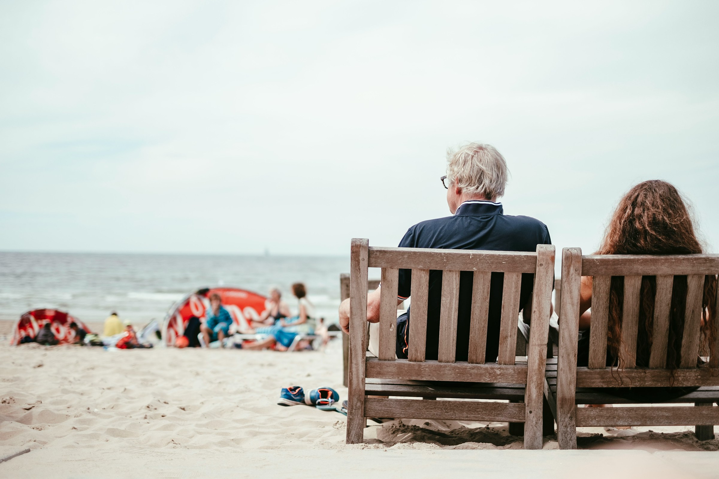 Middle aged men sitting in the beach and relaxing to prevent cell senescence