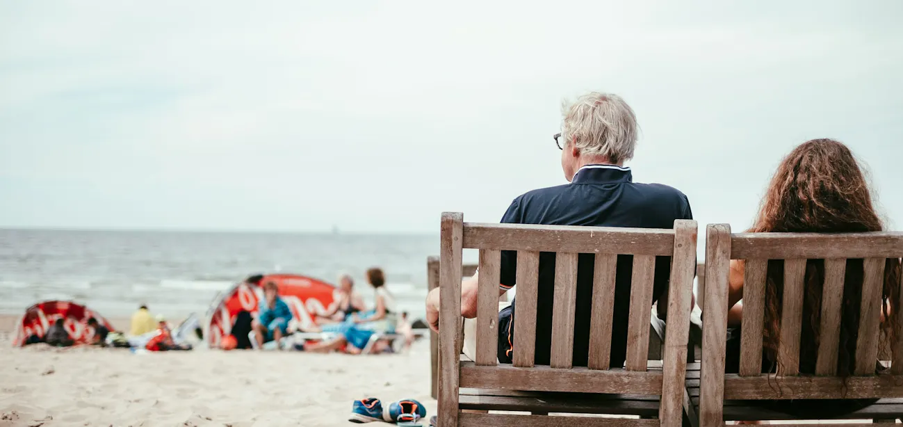 Middle aged men sitting in the beach and relaxing to prevent cell senescence
