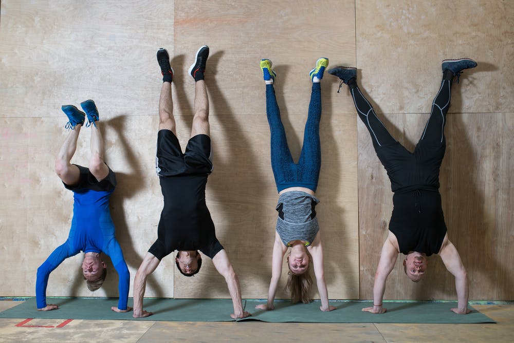 Group of people doing handstand push up