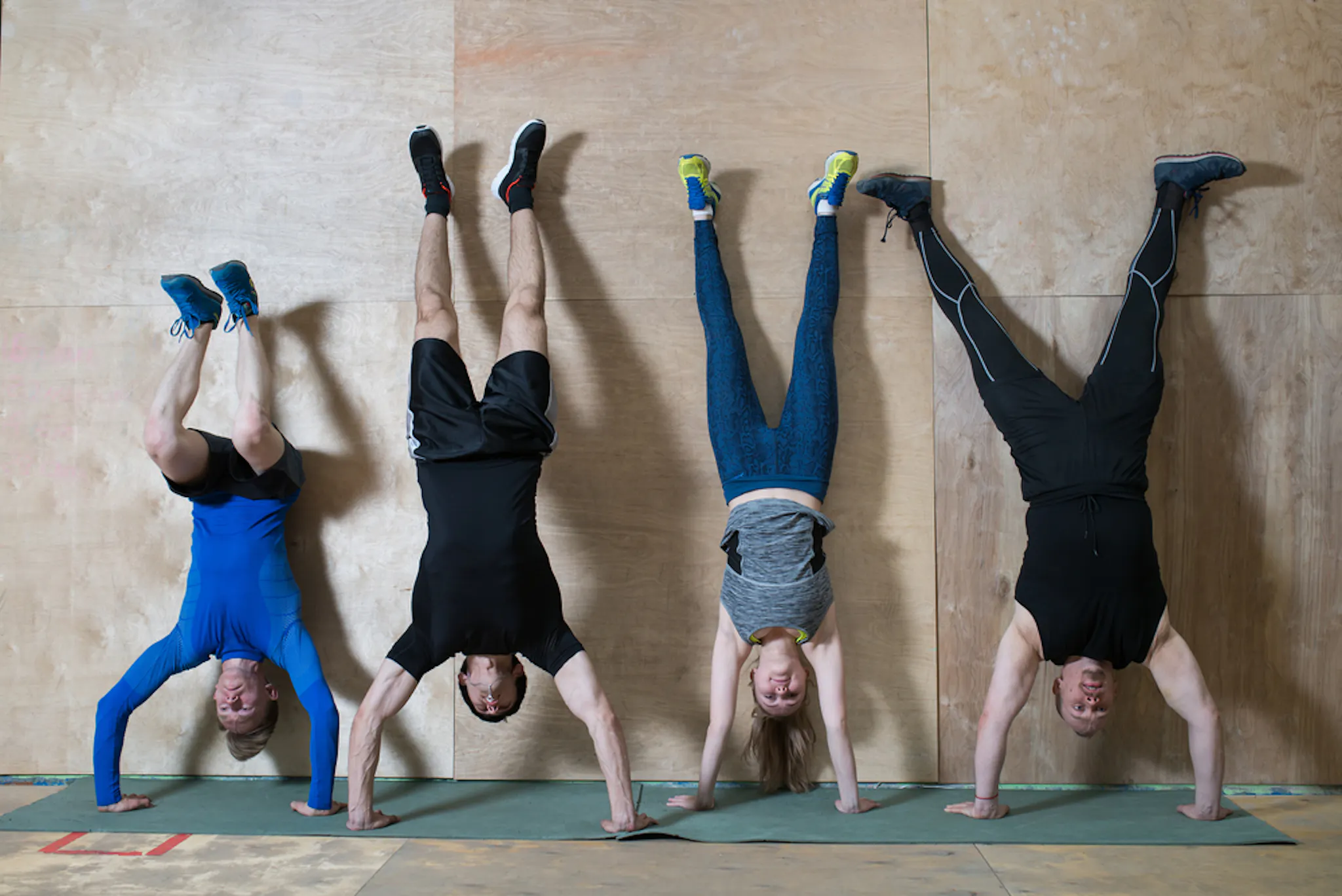 Group of people doing handstand push up