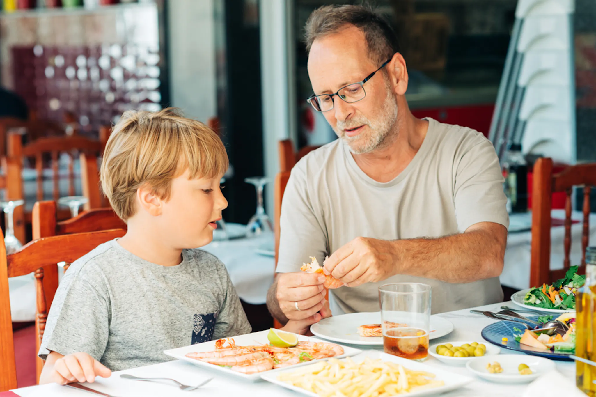 Older citizen eating shrimp with for HDL