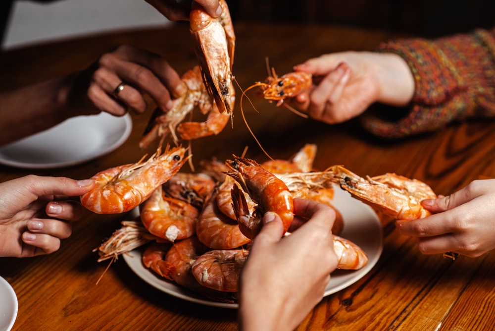 Cooked shrimp on plate with lemon and herbs