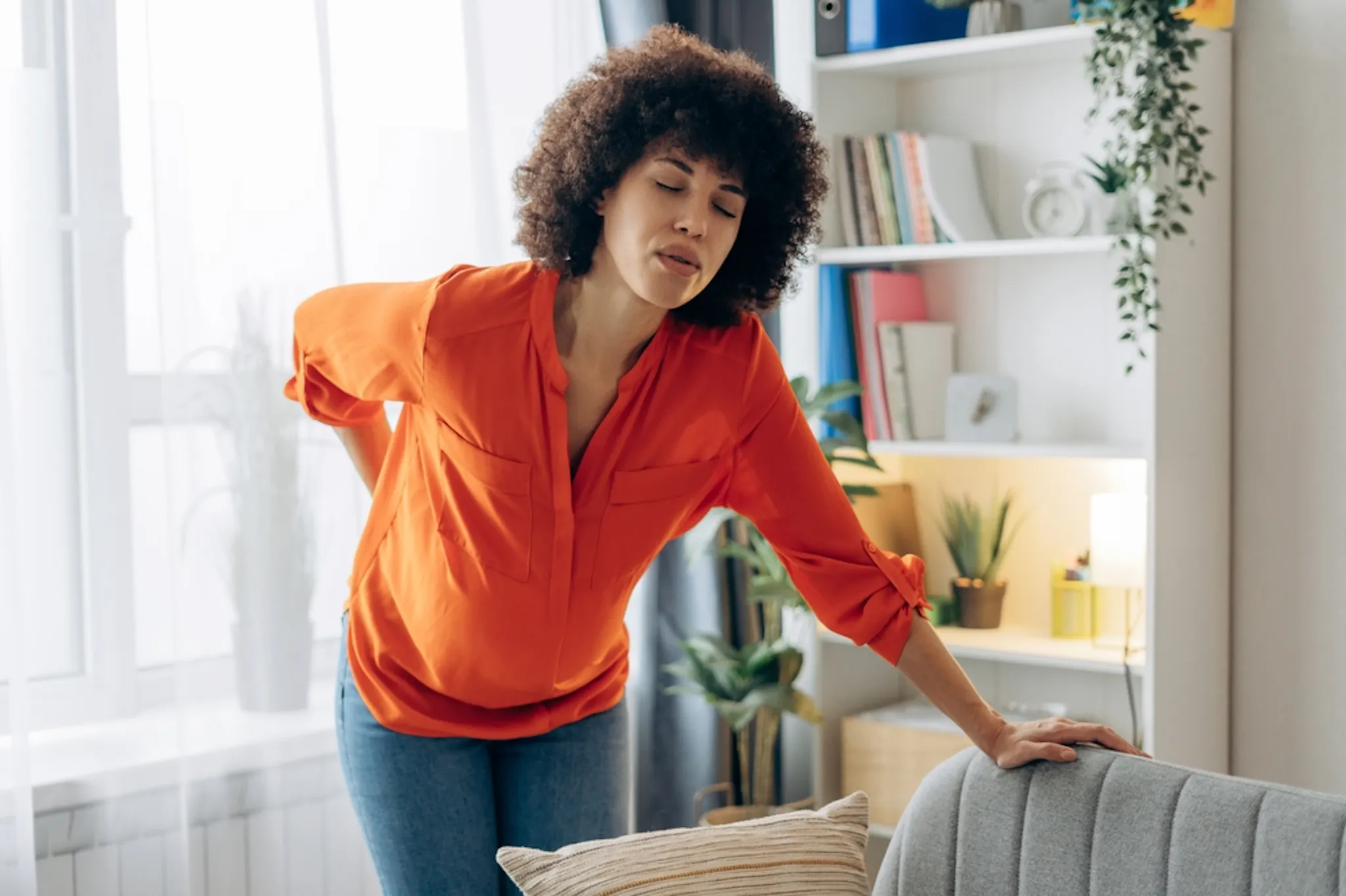 Woman holding sore legs due to anemia-related muscle pain