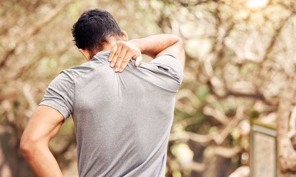 man holding sore a back due to anemia-related muscle pain