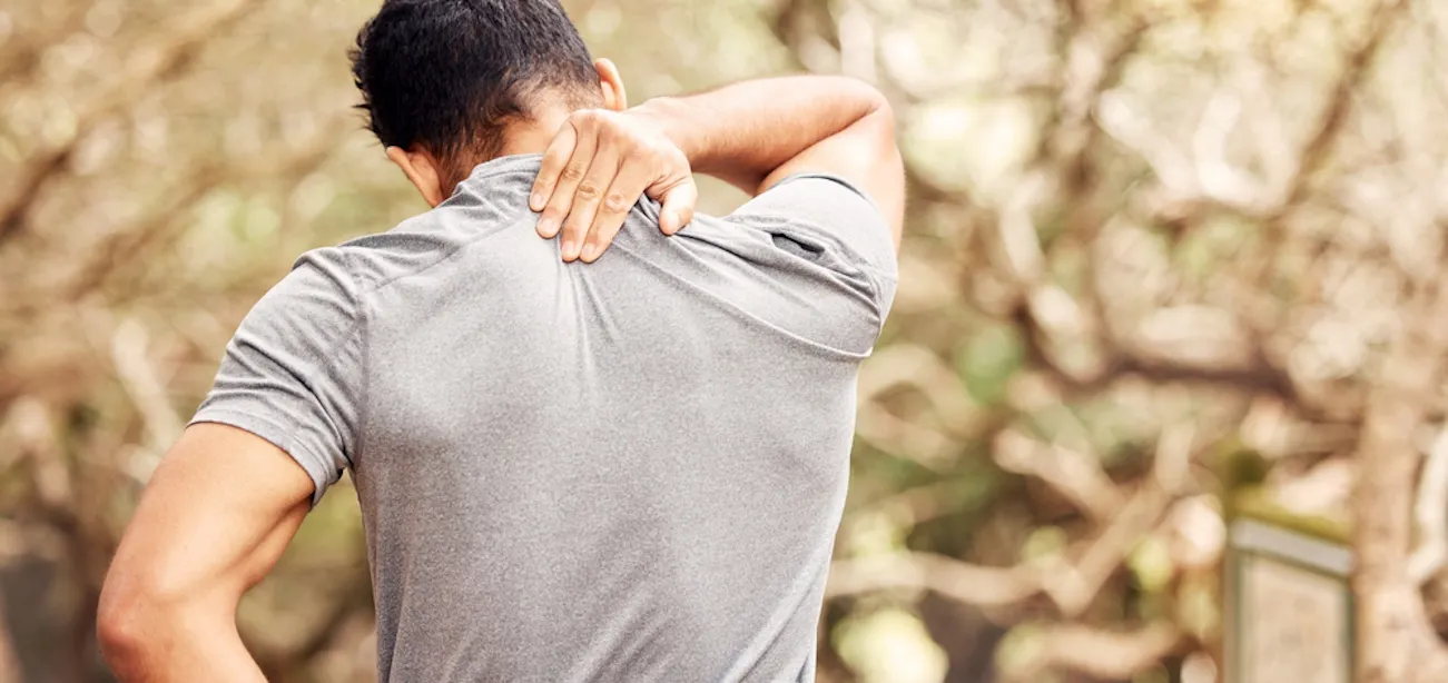 man holding sore a back due to anemia-related muscle pain