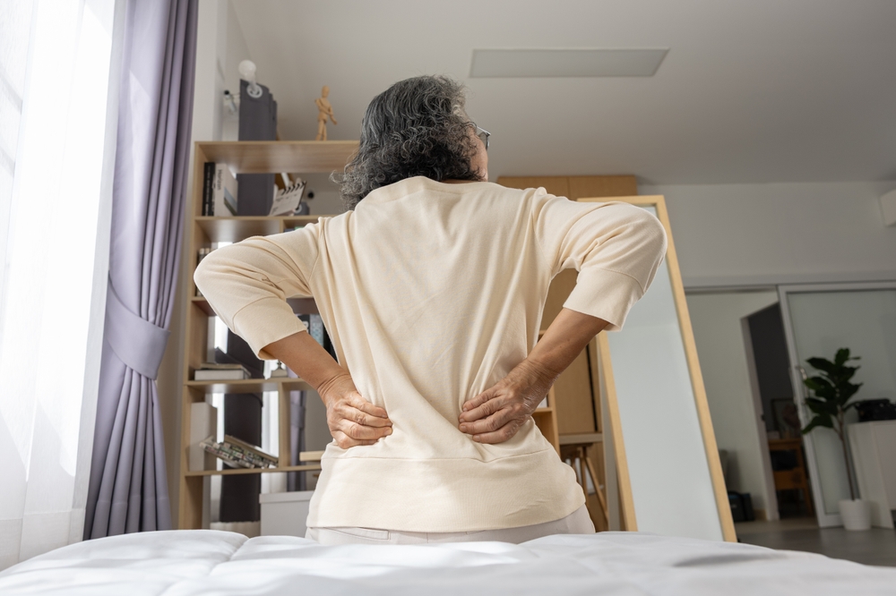 An older lady experiencing lower back pain