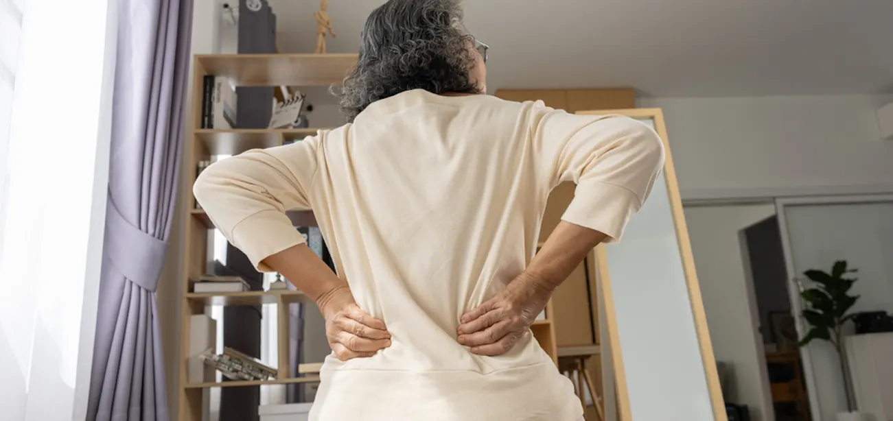 An older lady experiencing lower back pain
