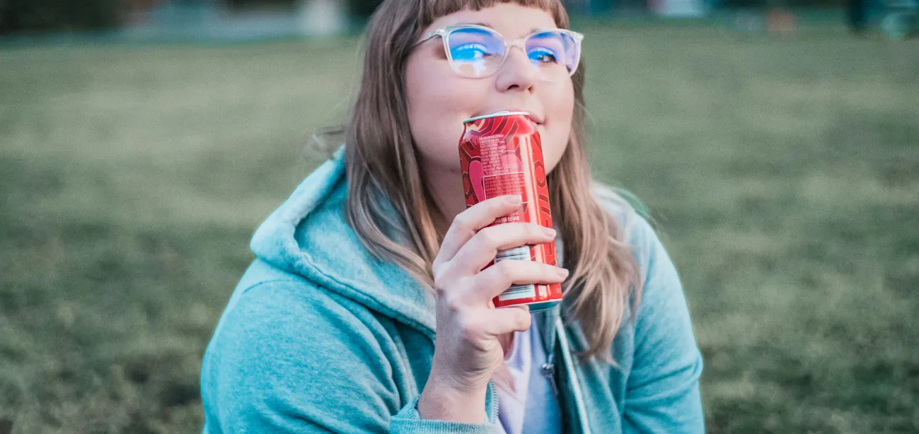 A lady taking soda with HFCS