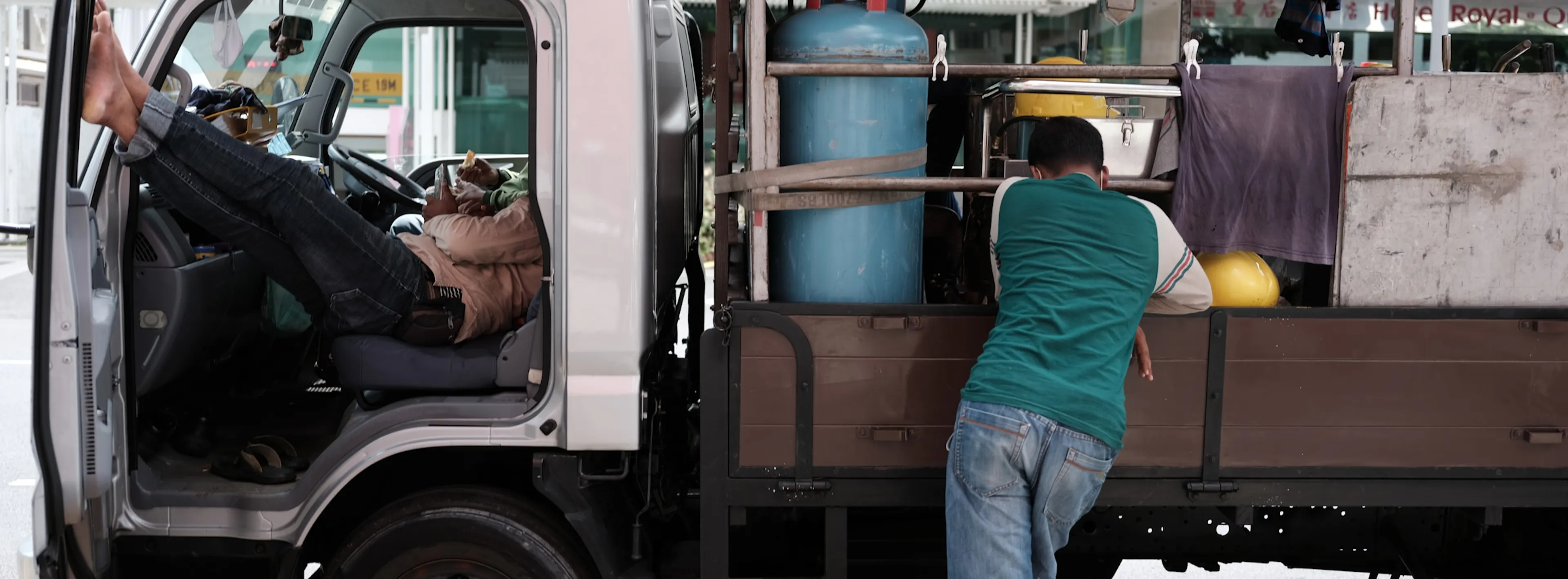 A truck driver taking a break to observe siesta