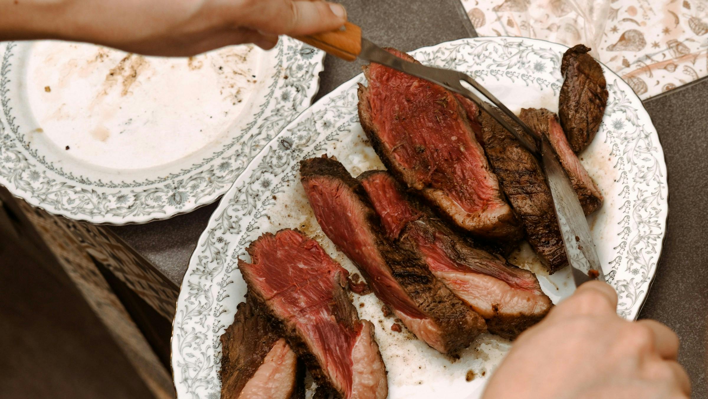 A person dishing beef for dinner