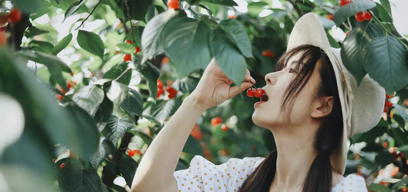 A lady eating berry for urolithin a