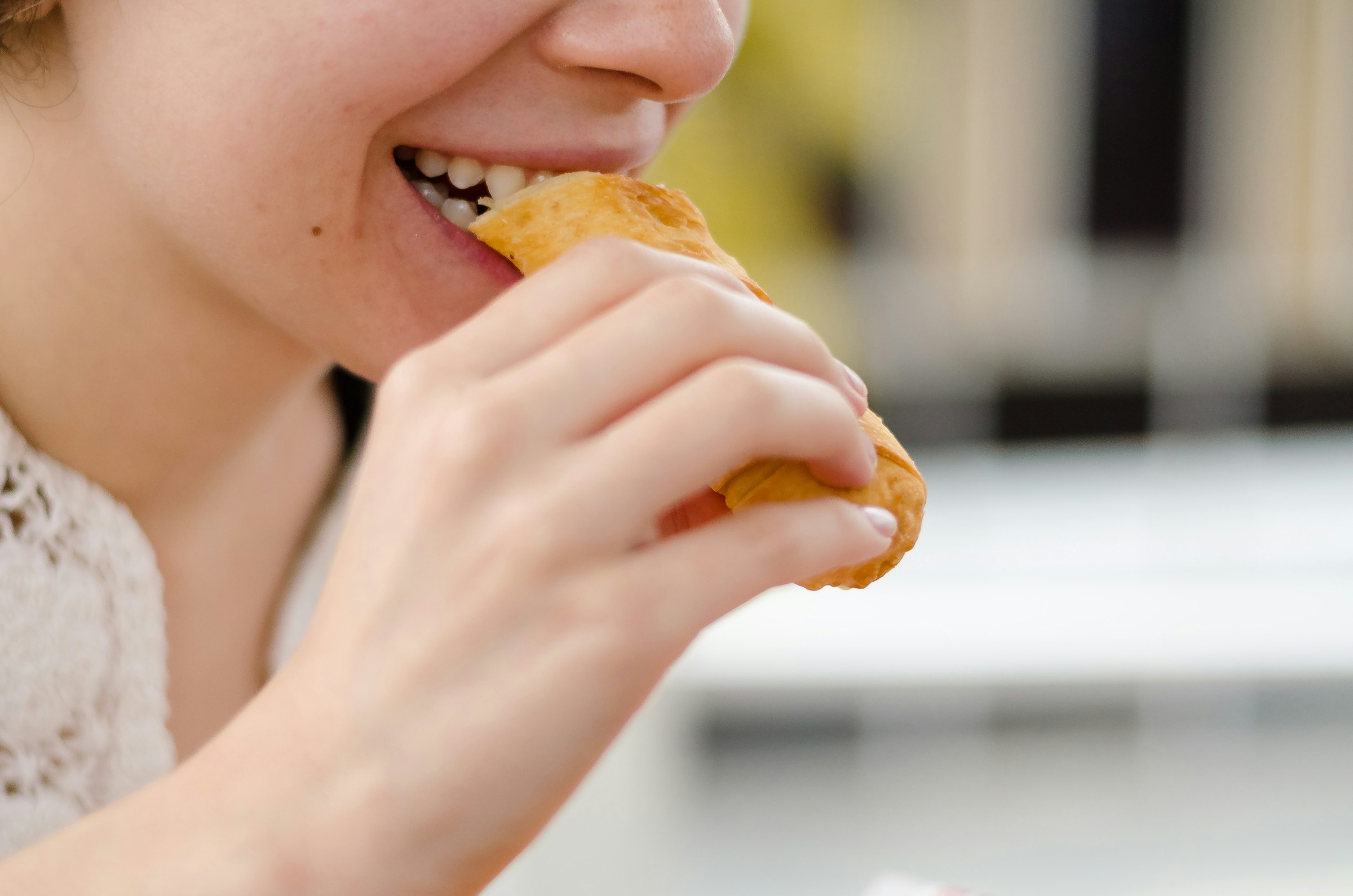 A lady eating a gluten heavy confectionary