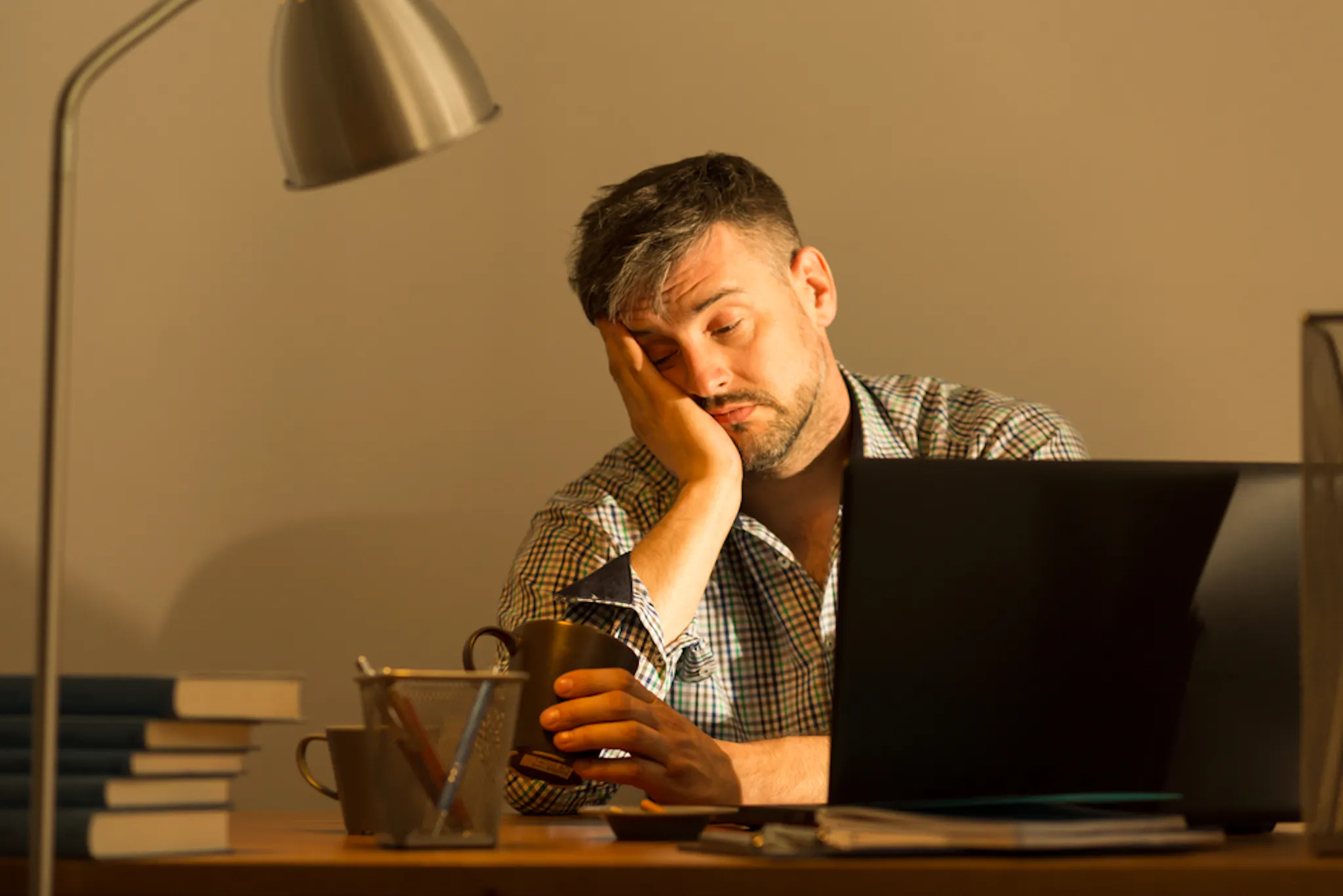 A person falling asleep during work