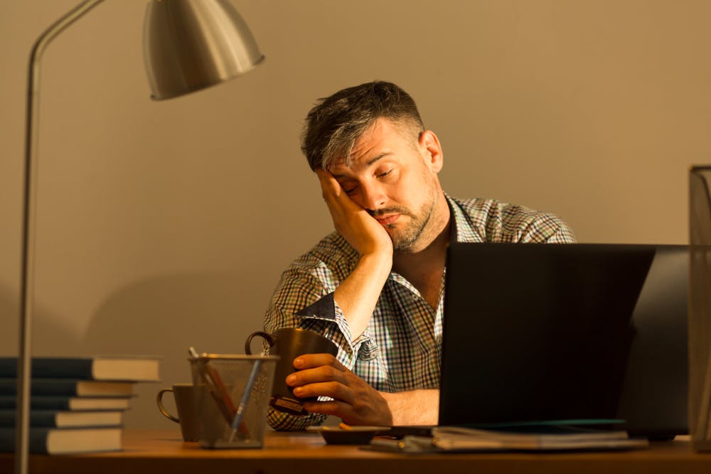 A person falling asleep during work