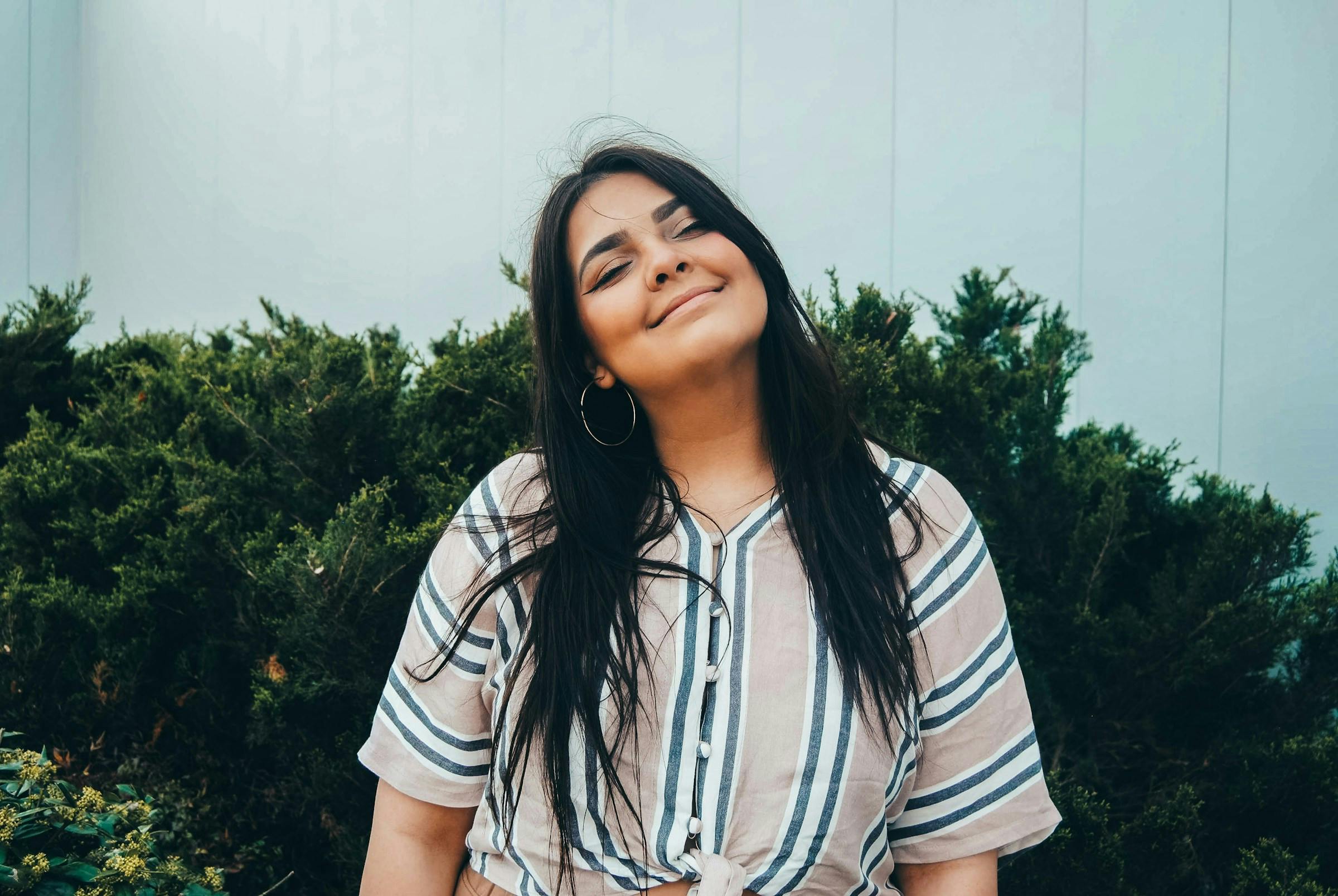 A happy lady showing her beautiful slim jawline