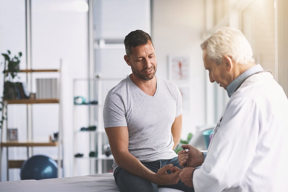 Man getting his lipid panel test done at the hospital