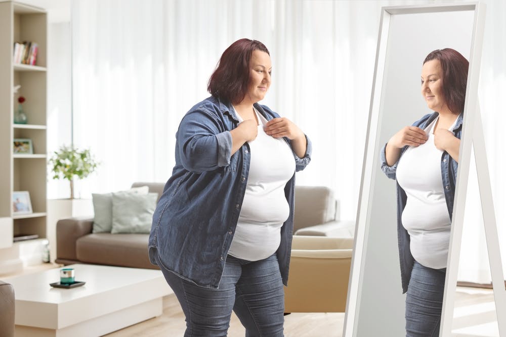 A lady checking herself in the mirror