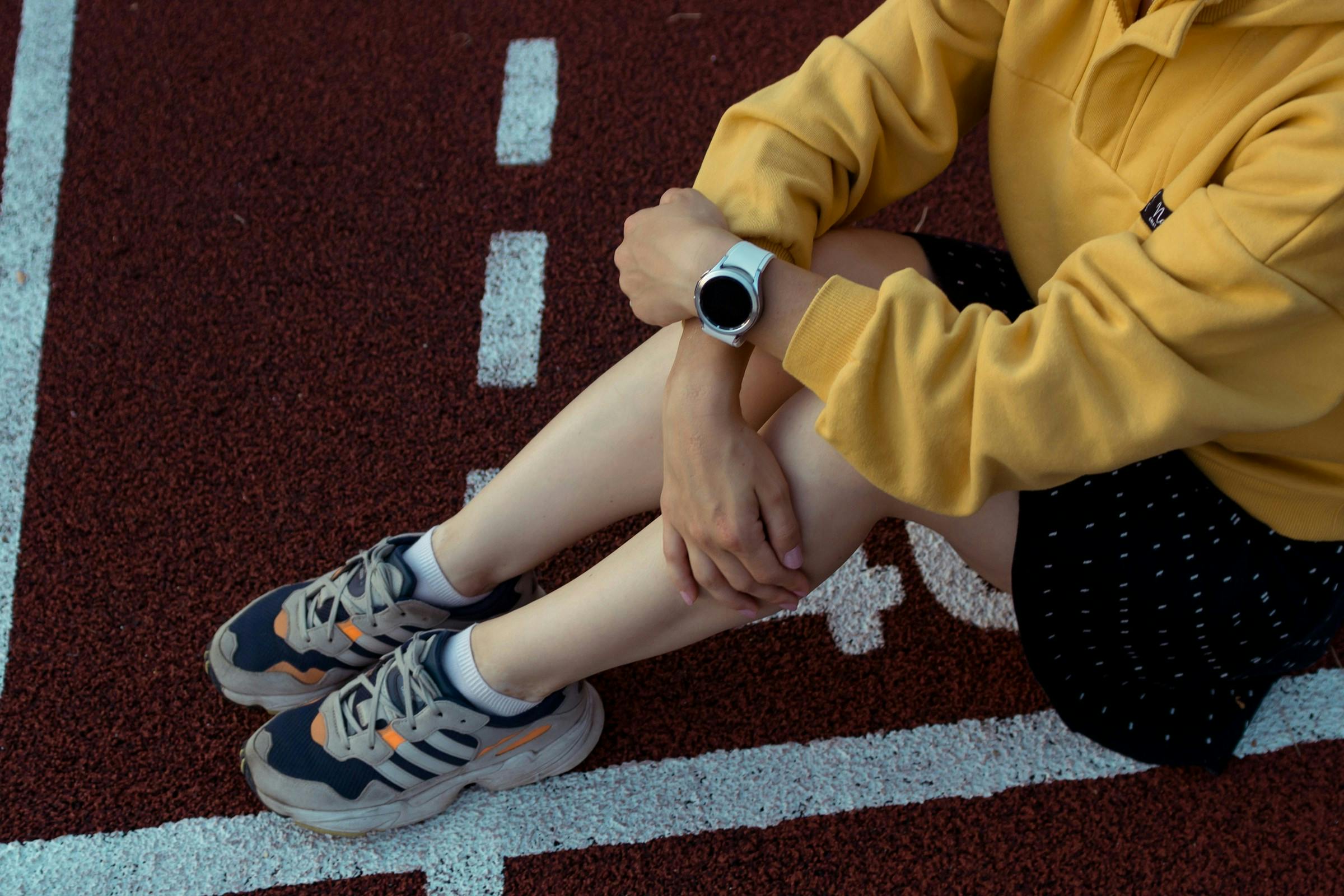 A person wearing fitness tracker on the track