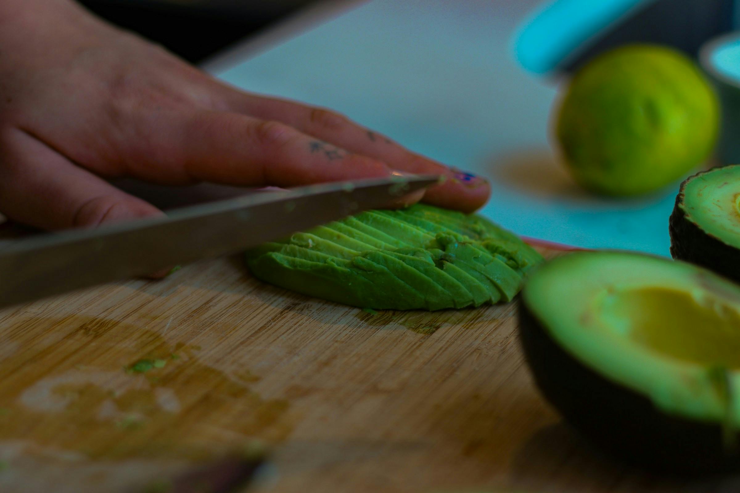 Person cutting avocado for meal
