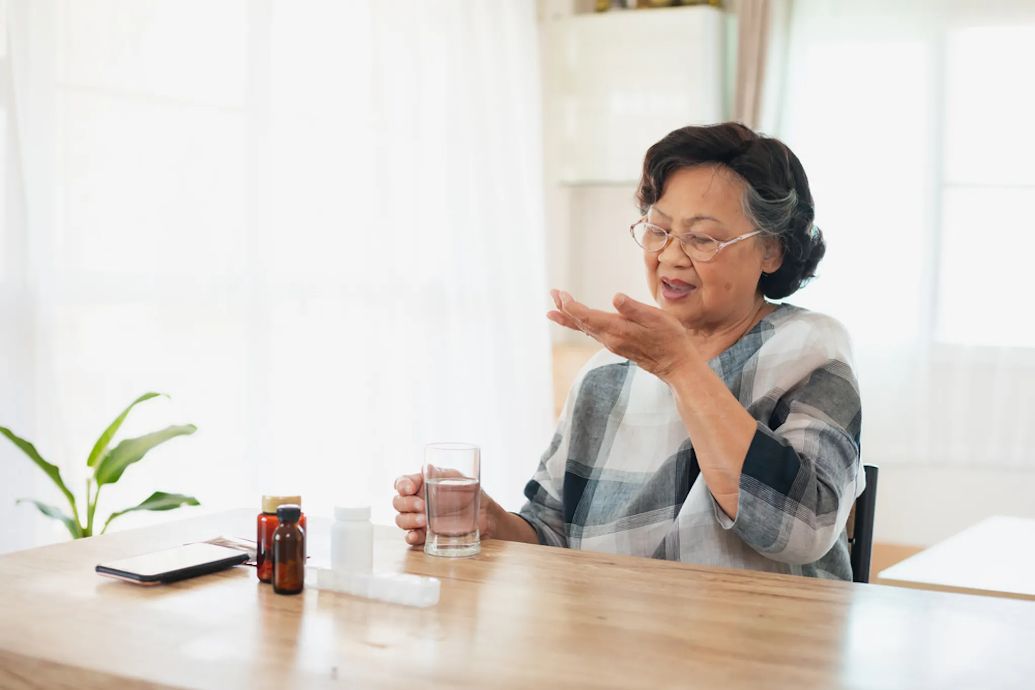 Middle-aged woman taking vitamin-d supplements for stronger bones