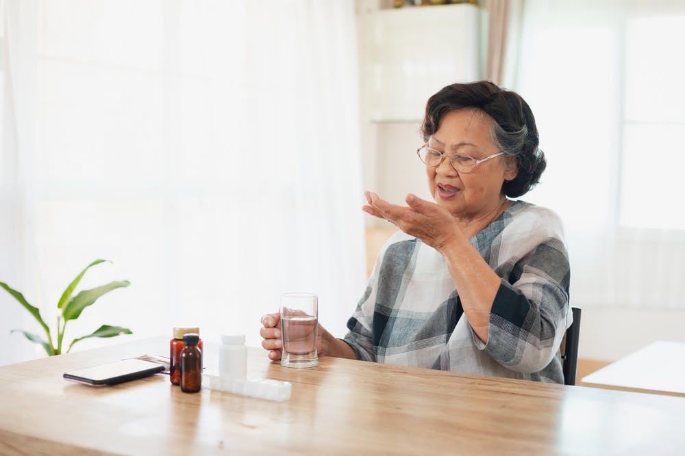 Middle-aged woman taking vitamin-d supplements for stronger bones