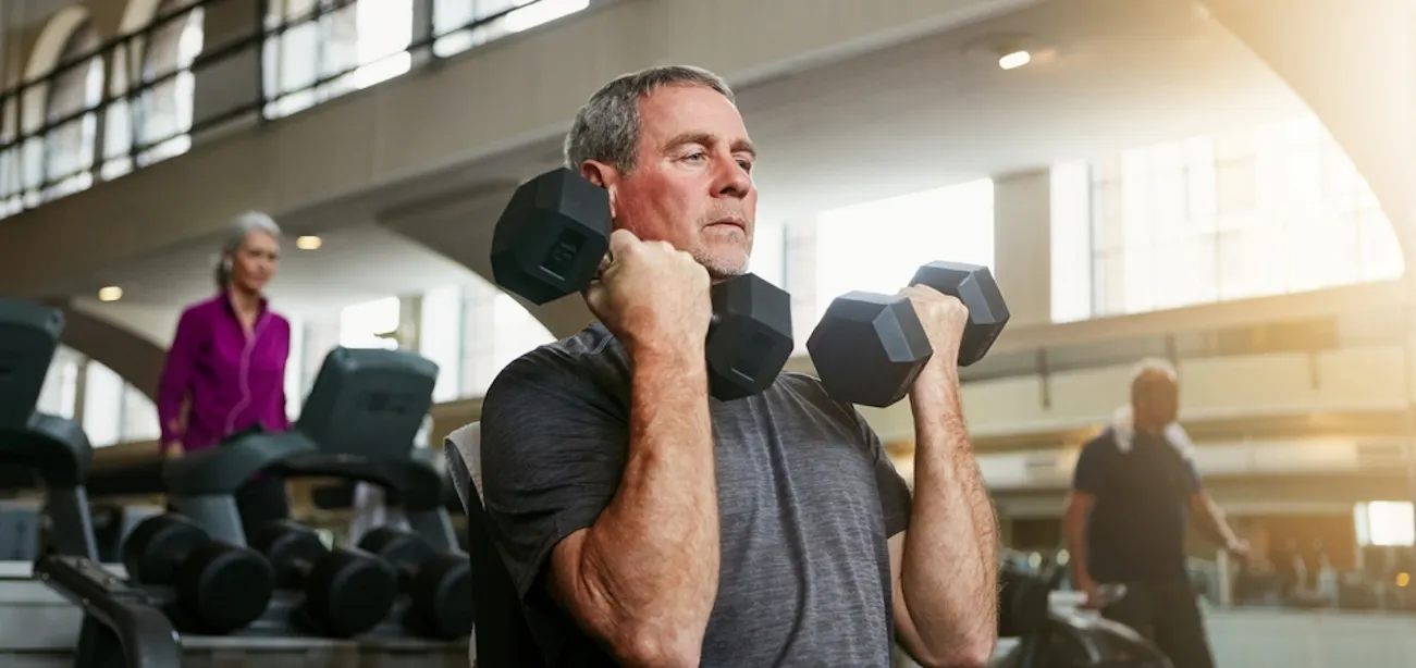 An image of an old man lifting weights for stronger bones